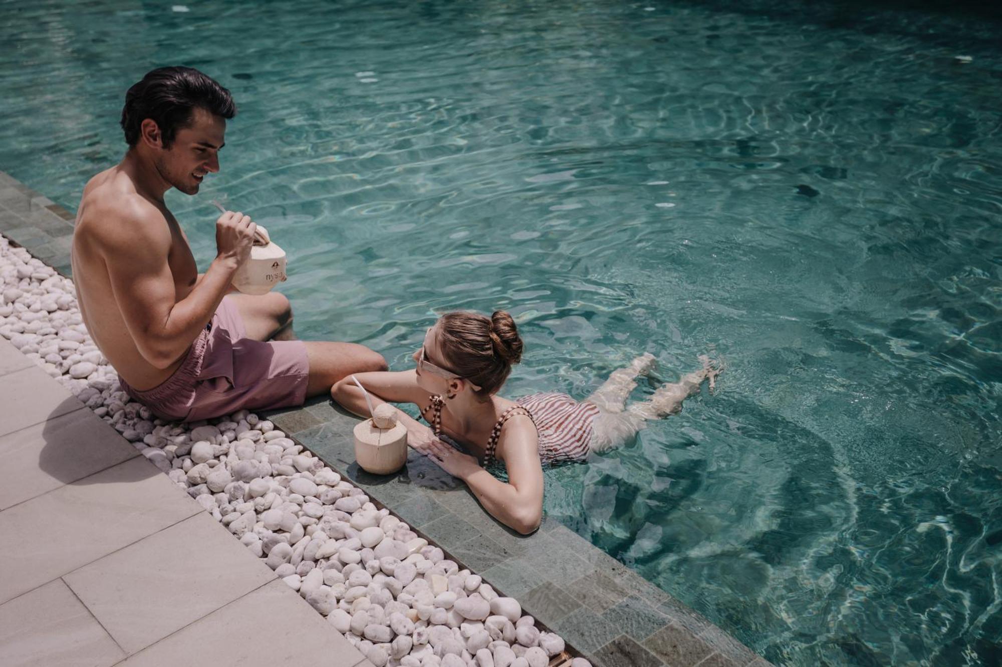 Nysa Hotel Bangkok Sukhumvit 11 Экстерьер фото A couple drinking coconut water in a swimming pool